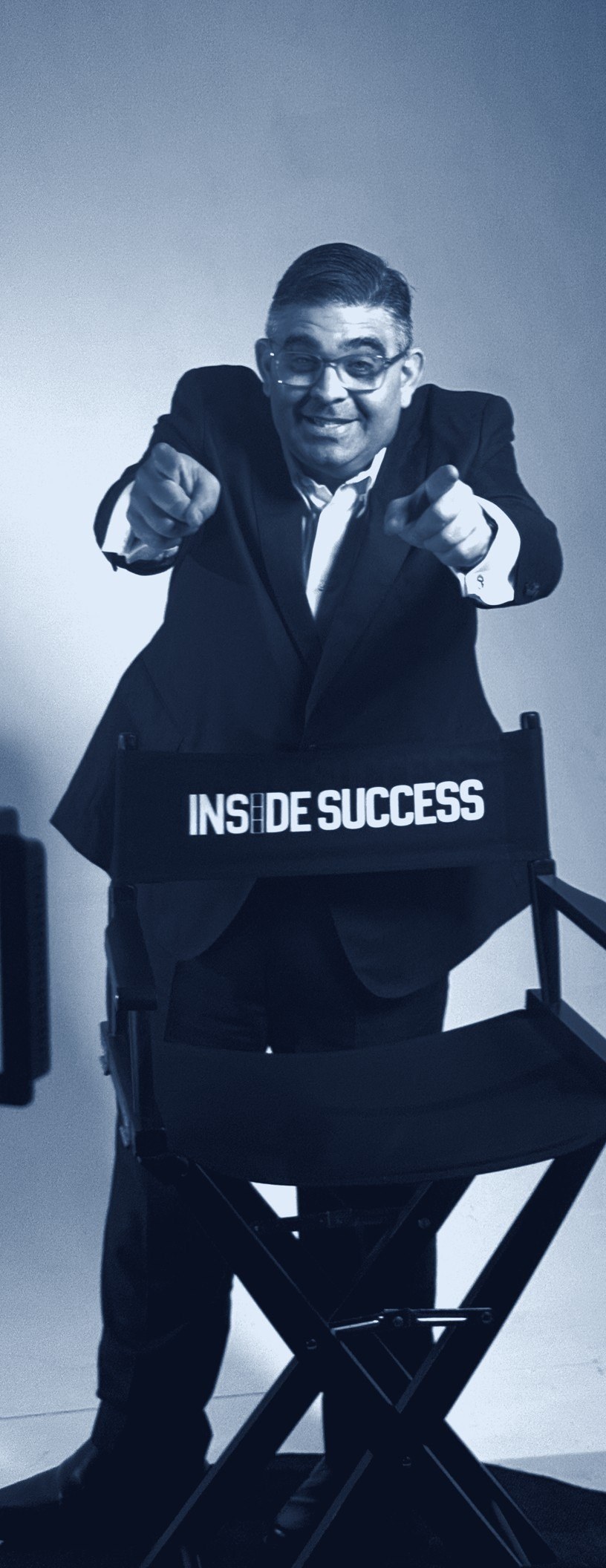 Steven E. Orr on the Inside Success set, standing behind a director’s chair that reads Inside Success